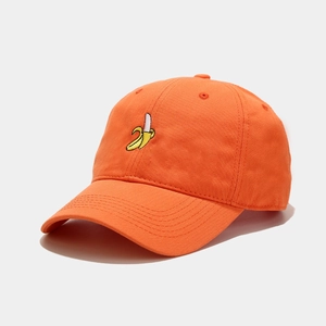 Detail of orange cotton baseball cap with embroidered banana and curved brim