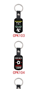 Detail of leather keychains with motivational football quotes and metal buckle finish