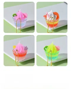 Close-up of mini resin sundae charms in pastel colors with golden bead chains
