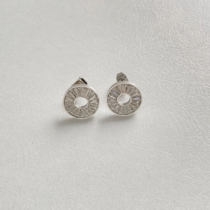Detailed macro view of silver stainless steel earrings with clear rectangular crystals