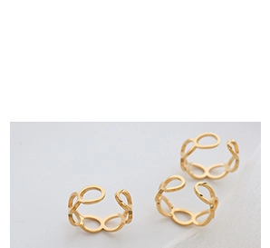 Close-up of three interlocking gold-plated rings with hollow geometric circles and oval shapes