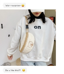Detail of cute white plush crossbody bag with cartoon embroidery and adjustable strap