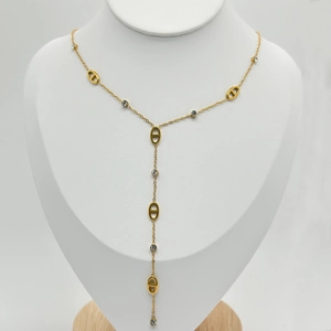 Detail of 18K gold-plated necklace with crystal-inlaid oval links and tassel drops