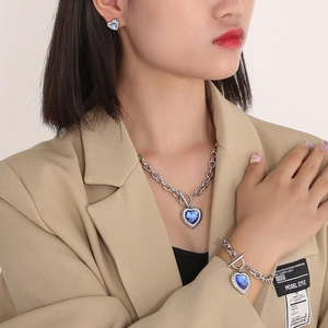 Detail of silver OT buckle Cuban chain set with blue heart-shaped crystal gemstones