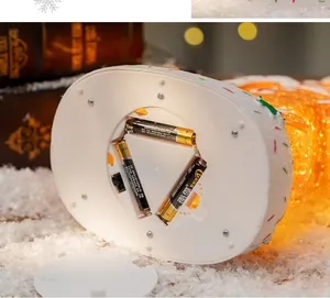 Detailed bottom view of Christmas music box with AA battery compartment and warm LED lights