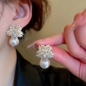 Elegant snowflake pearl earrings with silver finish and sparkling crystal accents for women