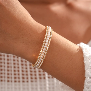 Detailed view of luxury multi-layer bracelet with pearls and crystals on gold plating