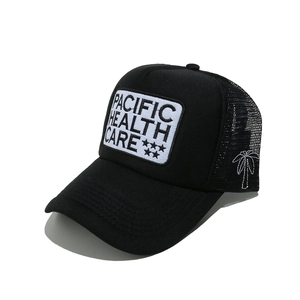 Detail of black trucker hat mesh back featuring a white embroidered palm tree pattern