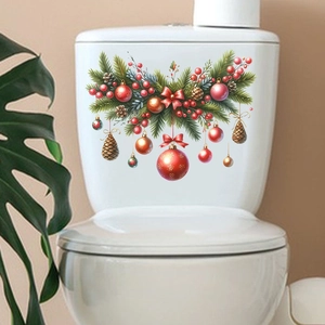 Close-up of Christmas toilet stickers with pine needles, red balls, and gold bells decor