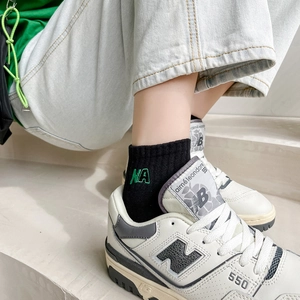 Japanese style black cotton crew socks with green NA embroidery and ribbed texture