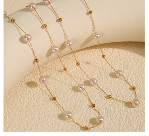Macro detail of 18K gold star pearl necklace with elegant beads on artistic pedestal