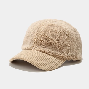 Detail of beige fleece baseball cap showing thick texture and corduroy brim surface