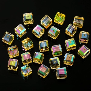 Macro shot of 4-8mm amber cube crystal beads with aurora AB coating on black background