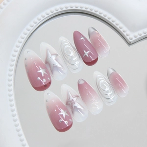 Pink gradient press-on nails with 3D spiral texture and silver star patterns in almond shape