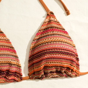 Close-up of multicolor striped crochet bikini top with textured knit and orange ties