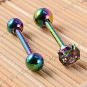 Macro shot of rainbow stainless steel tongue rings with zircon stone and smooth metal balls