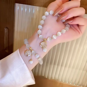 Elegant cat's eye stone bead bracelet with a gold cat-shaped lucky bell charm for women