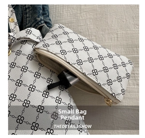 Detail shot of mini coin purse with S-pattern monogram and gold zipper closure
