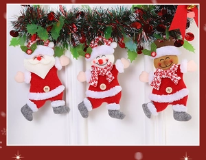 Three festive Christmas plush figures of Santa Claus, Snowman and Reindeer hanging in a row