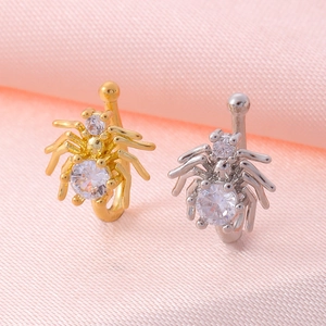 Macro shot of spider-shaped U-shaped nose clips with inlaid zircons on pink silk fabric