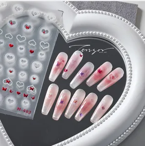 Macro view of M-493 nail stickers featuring red butterflies and white pearl heart patterns