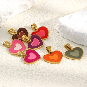 Macro detail of multi-colored enamel heart pendants with 18K gold-plated stainless steel rims