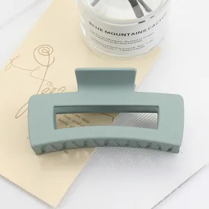 Detail of sage green matte square hair claw clip with smooth frosted finish and strong grip