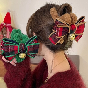 Plush Christmas bow hair claw clip with golden bells in red and green festive plaid style