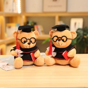 Detail of graduation teddy bears with black academic gowns and mortarboard hats