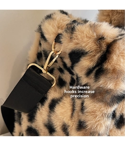 Detail of leopard print plush bag showing golden metal hook and black wide strap