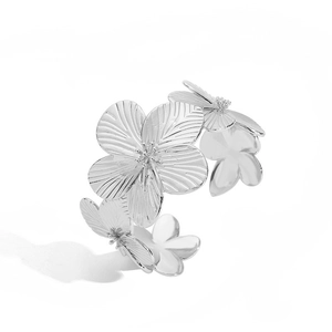 Detail view of silver floral cuff bracelet with layered petal design and metallic texture