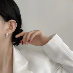 Close-up of minimalist 925 silver irregular hammered texture ear cuffs on a model