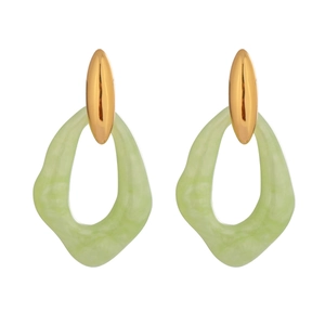 Macro shot of green irregular teardrop earrings with elegant golden metal studs