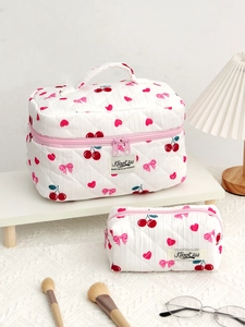 Quilted cotton makeup bag set with cherry and bow patterns, featuring two storage pouches