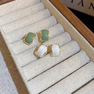 Minimalist geometric stud earrings set in light green and pearl white finish