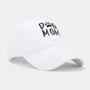 Detailed view of DOG MOM embroidery on a white washed cotton baseball cap with curved brim