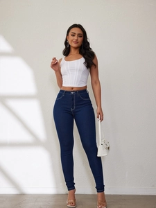 Close-up of slim fit high-waisted navy blue denim jeans with elastic skinny leg cut