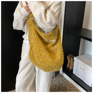 Ginger yellow plush tote bag with white decorative label and wide shoulder strap style