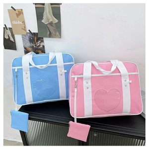Detail of JK style ita bags with heart windows in pastel pink and blue oxford fabric