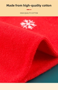 Detailed close-up of high quality cotton fabric with white snowflake pattern in red