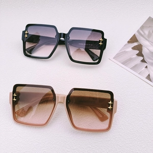 Fashionable large square frame sunglasses in black and nude pink with gold star details
