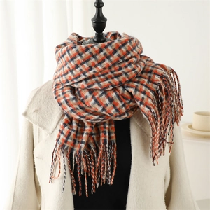 Classic British plaid scarf in orange and navy blue with warm tassels on white coat