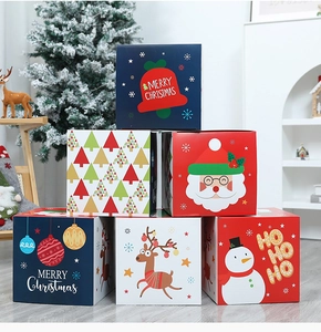 Close-up of square Christmas gift boxes featuring cartoon Santa and Snowman patterns