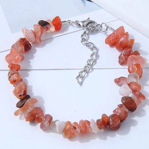 Detailed macro view of red agate stone bracelet with silver lobster clasp and chain