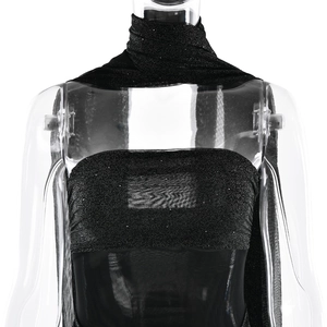 Detail of black strapless evening dress featuring silver glitter fabric and sheer mesh