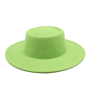Detailed view of the grass green flat top wool felt hat with structured brim and stitching