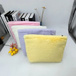 Detailed pile of macaron plush cosmetic bags with colorful dots and metal zipper