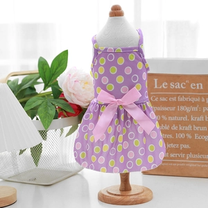 Close-up of lightweight purple polka dot pet dress with a decorative pink bow on mannequin