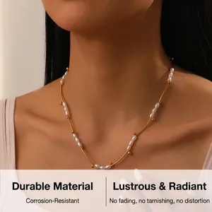 Detail of elegant gold-plated necklace with oval pearls and tube beads on a model