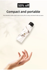Compact five-fold travel umbrella shown against a hand to emphasize portable pocket size